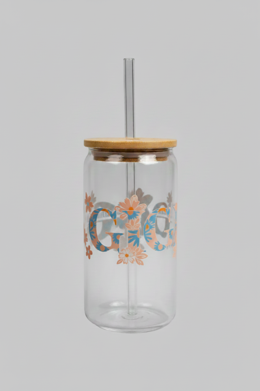 Clear glass jar with a wooden lid held by a hand, with a blurred background.